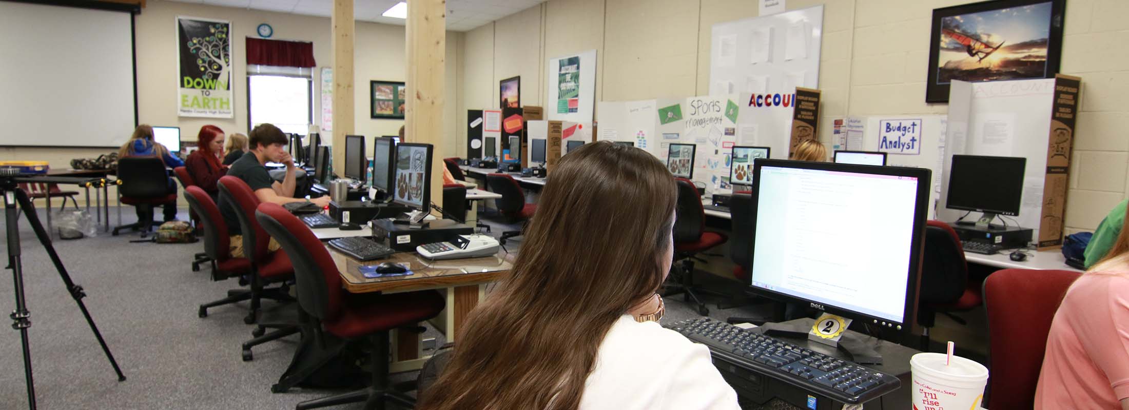Students viewing a desktop computer.