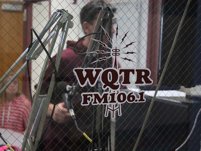 A red sticker logo of WQTR FM 106.1 displayed on the window.